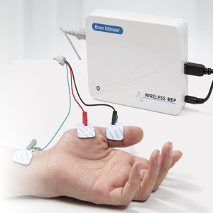 The Brain Ultimate MEP Module for M100 TMS System. In this picture a MEP module is a while box with electrode leads coming out of it and attaching across the thumb muscles of an out stretched hand.
